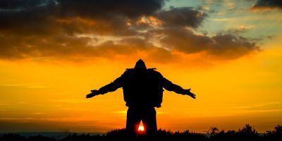 silhouette of man spreading its arm